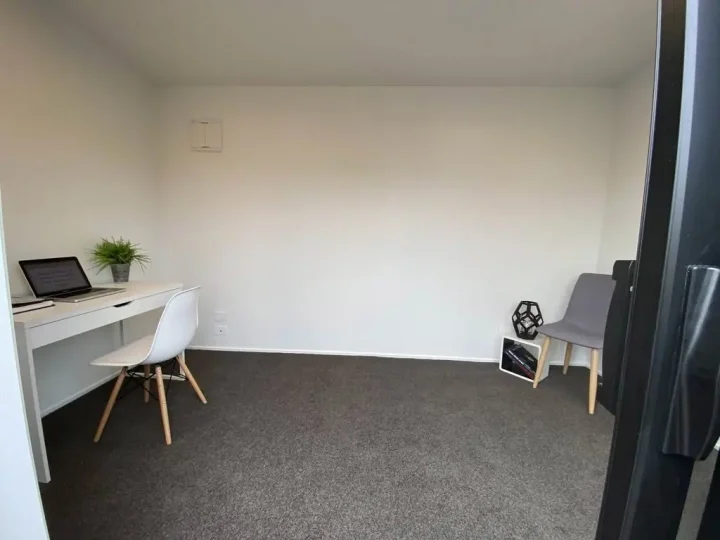 Cabin set up as an office, with a desk, chairs and carpet