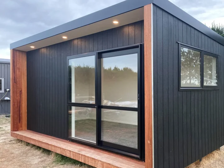 Black cabin with a kwila surround, a side window and soffit lights on