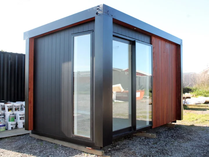 Black cabin with a glazed corner and a kwila end wall
