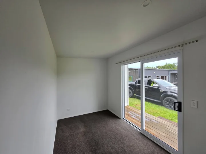 Carpeted cabin interior with the sliding door open onto the deck