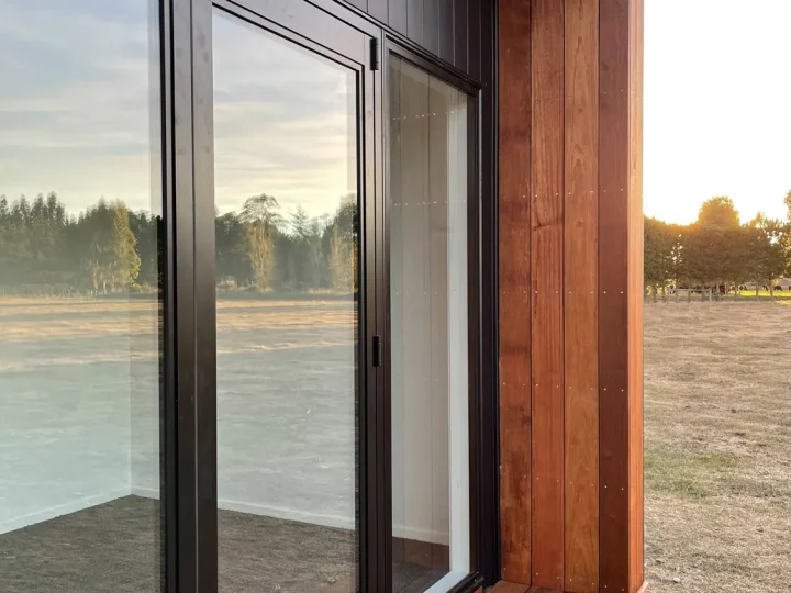 Close view of a glazed sliding door, kwila reveal and deck